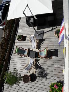 an overhead view of a patio with chairs and an umbrella at Hôtel Ker-Noyal Quiberon Plage in Quiberon