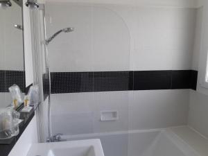 a bathroom with a shower and a sink at Hôtel Ker-Noyal Quiberon Plage in Quiberon