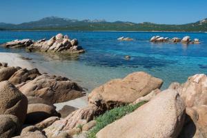 a group of rocks in the water near the shore at Hotel Il Piccolo Golf in Porto Cervo