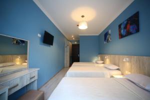 A bed or beds in a room at Hotel Soft