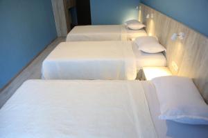 A bed or beds in a room at Hotel Soft