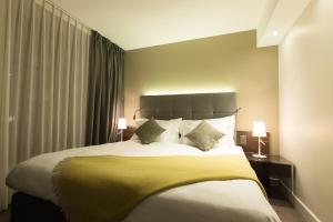 En eller flere senger på et rom på Hôtel des Voyageurs Boutique