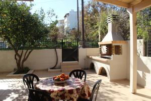 a table with a bowl of fruit on a patio at Athina's Guesthouse in Rethymno