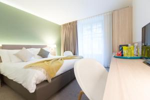 En eller flere senger på et rom på Hôtel des Voyageurs Boutique