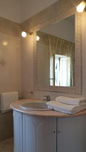 a bathroom with a sink and a large mirror at Filù Rooms Paradise Tower in Minori
