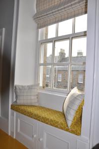 a window seat with pillows in front of a window at Emahroo Cullen in Cullen