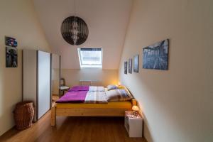 a bedroom with a bed with a purple blanket at Moseltalblick in Bernkastel-Kues