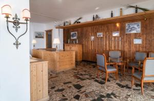 a room with wooden walls and a table and chairs at Hotel Schwarzsee in Zermatt