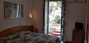 a bedroom with a bed and a sliding glass door at Hotel Tirreno in Rome