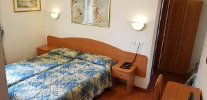 Postel nebo postele na pokoji v ubytování Hotel Tirreno