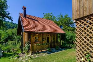 Brod na Kupi的住宿－Osmak in Gusti Laz (Haus für 4 Personen)，一座带红色屋顶的小木房子