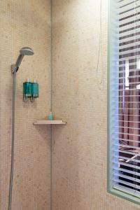 a shower in a bathroom with a glass door at Hotel Rival in Stockholm