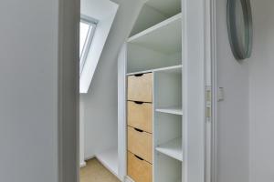 a room with white shelves and a window at Ferienhaus Lochterbarig in Munkmarsch +2 photos
