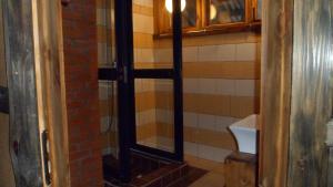 a shower with a glass door in a bathroom at Viruna Farm in Kiraste +76 photos