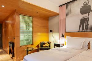 a bedroom with a bed and a large painting on the wall at Hotel Rival in Stockholm