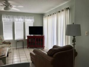 ein Wohnzimmer mit einem Sofa und einem Flachbild-TV in der Unterkunft Southern Sands 104 Condo in Gulf Shores