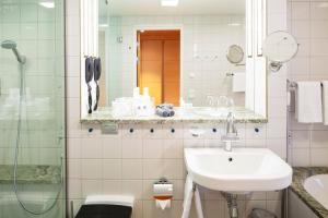 a bathroom with a sink and a shower at Hotel Rival in Stockholm