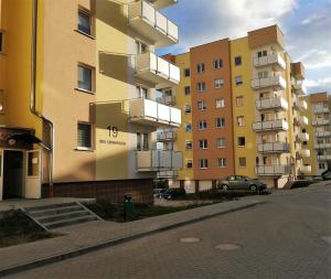 a building with balconies on the side of a street at Studio A1 in Gorzów Wielkopolski
