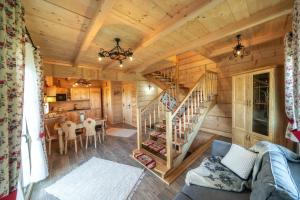 a living room with a staircase in a log cabin at Domek u Kowola in Szaflary