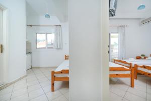 a room with two beds and a table at Villa Margarita in Limenaria