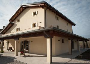 a large white building with a roof at Klanjscek Wine&Stay in Gorizia