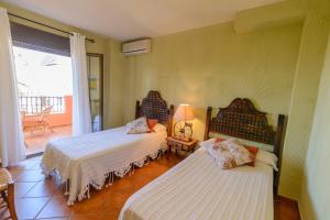 Postel nebo postele na pokoji v ubytování Hotel Rural Sierra Tejeda