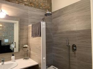 a bathroom with a shower and a sink at Casa de piedra adaptada en LEscala in L'Escala