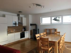 a kitchen and dining room with a table and chairs at Sonnenalpe Apartments Nassfeld in Sonnenalpe Nassfeld