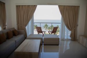 
a living room filled with furniture and a window at Prime Wave Residence in Mount Lavinia
