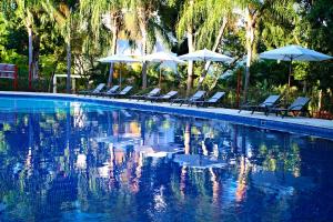a swimming pool with lounge chairs and umbrellas at Bahia Principe Luxury Sian Ka´an - Adults Only - All Inclusive in Akumal