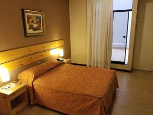 Postel nebo postele na pokoji v ubytování Hotel El Brujo Centro Histórico