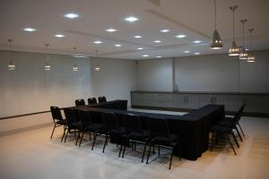 a conference room with a long table and chairs at Maximus Sottile - by Easy Hotéis in Ji-Paraná +54 photos