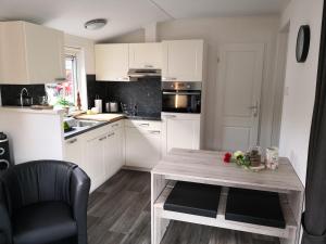 a kitchen with a wooden table with flowers on it at Ferienhaus MaLeFi 1 am Gülser Moselbogen in Koblenz