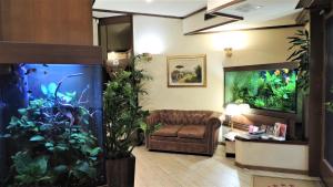 a living room with a large fish tank at Hotel Accursio in Milan