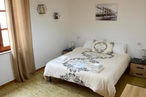 a bedroom with a bed with a black and white comforter at Mille Soli Bed and Breakfast in Buggerru