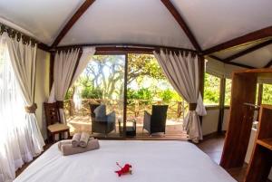 a bedroom with a large bed in a tent at Vaihu Nui Bungalow-Glamping in Hanga Roa