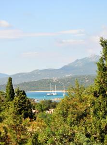 a view of a bay with a boat in the water at Hotel Il Piccolo Golf in Porto Cervo