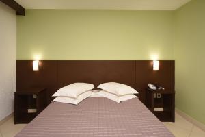 Postel nebo postele na pokoji v ubytování Hotel Dunamys Curitiba