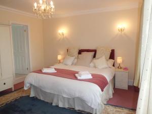 a bedroom with a bed with two towels on it at The Chantry in Callington