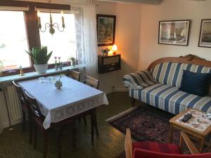 a living room with a table and a couch at Cosy old house Vágar next to Mykines in Sørvágur