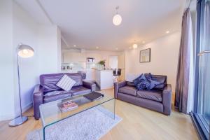 a living room with two couches and a table at Cleyro Serviced Apartments - Finzels Reach in Bristol