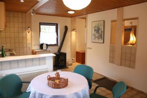 a kitchen with a table and chairs with a basket on it at FeWo Landhaus Ederlust HeilungsRäume eV in Hatzfeld