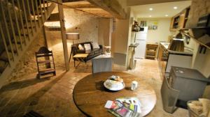 a room with a table and a living room and a kitchen at LES LIMORNIERES in Le Grand-Pressigny