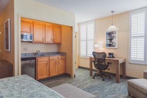 a kitchen with a desk and a chair in a room at The Parkview Hotel in Syracuse