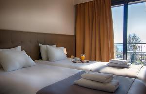 Postel nebo postele na pokoji v ubytování Galaxy Hotel