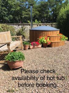 a sign that says please check availability of hot tub before gardening at Cumledge Yew Trees Cottage in Duns