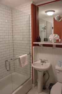 a bathroom with a sink, toilet and bathtub at 1886 Crescent Hotel and Spa in Eureka Springs