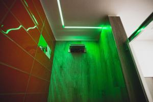 a green corridor with a green light in a bathroom at Hotel Fiera Wellness & Spa in Bologna