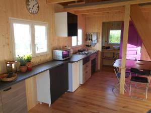 a kitchen with a counter and a table in a room at le chalet in Theys
