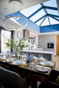 a kitchen with a large wooden table with glasses on it at The Cottage and The Nook in Gretton